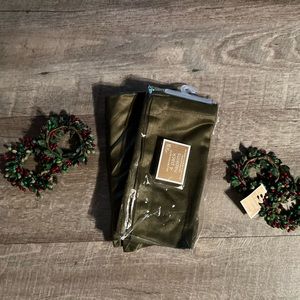 Set of four olive colored cloth napkins with four berry napkin rings